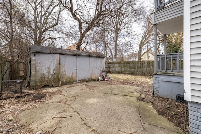 view of patio with an outdoor structure and fence