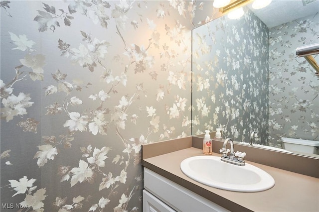 4339 Sierra Dr, Copley, OH 44321 - half bathroom featuring wallpapered walls, toilet, and vanity