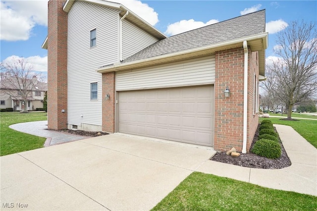 4339 Sierra Dr, Copley, OH 44321 - view of side of property with brick siding, an attached garage, driveway, and a yard
