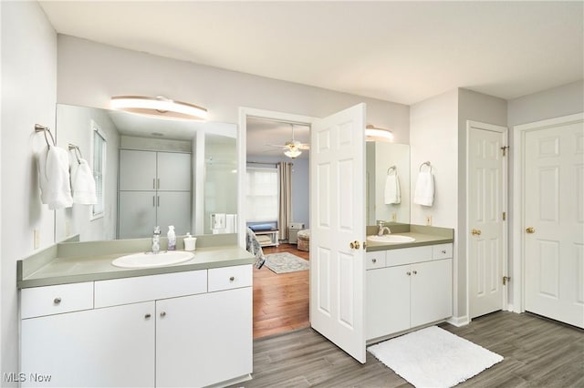 4339 Sierra Dr, Copley, OH 44321 - full bathroom with ceiling fan, two vanities, wood finished floors, and a sink