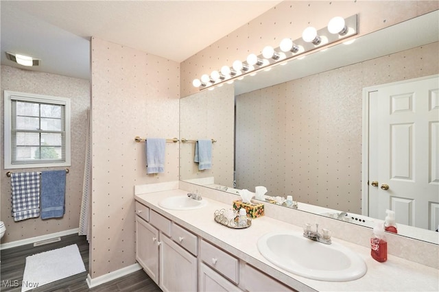 4339 Sierra Dr, Copley, OH 44321 - full bathroom with toilet, wood finished floors, a sink, and double vanity