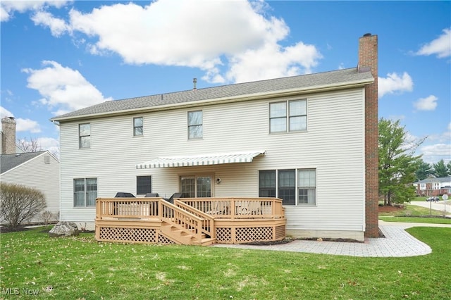 4339 Sierra Dr, Copley, OH 44321 - back of property with a lawn, a chimney, and a deck