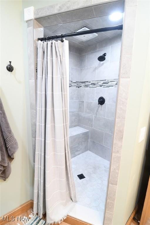 full bath with a shower stall