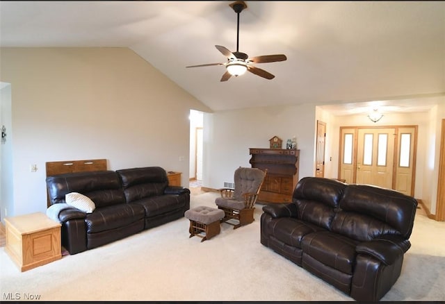 living room featuring ceiling fan, carpet flooring, and vaulted ceiling
