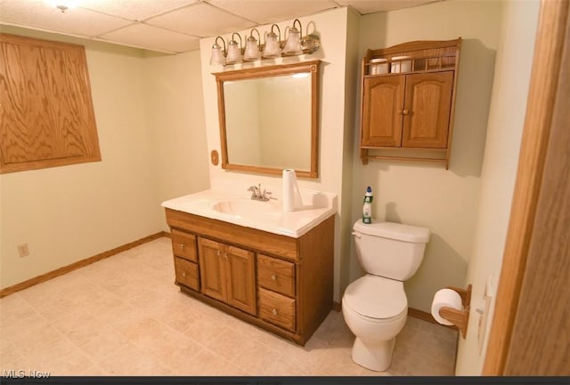 bathroom featuring toilet, vanity, and baseboards