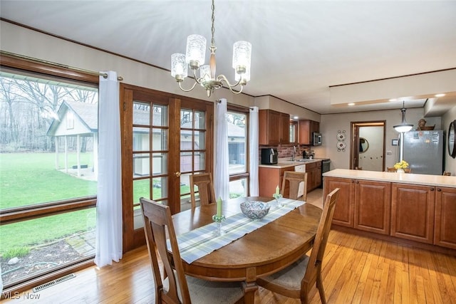 3035 Hamilton Rd, Medina, OH 44256 - dining space featuring visible vents, light wood-type flooring, and an inviting chandelier