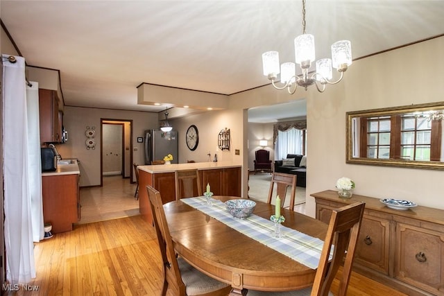 3035 Hamilton Rd, Medina, OH 44256 - dining space with light wood-style flooring and an inviting chandelier