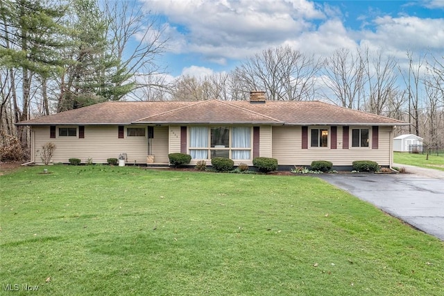 3035 Hamilton Rd, Medina, OH 44256 - ranch-style home featuring aphalt driveway, a front yard, roof with shingles, and a chimney