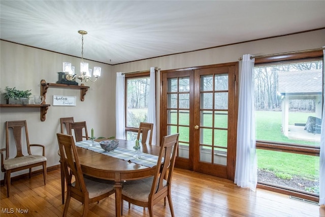 3035 Hamilton Rd, Medina, OH 44256 - dining room with visible vents, hardwood / wood-style floors, french doors, baseboards, and a notable chandelier