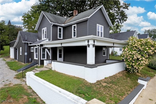 401 N Market St, Shreve, OH 44676 - view of front facade featuring a front lawn, covered porch, and a chimney