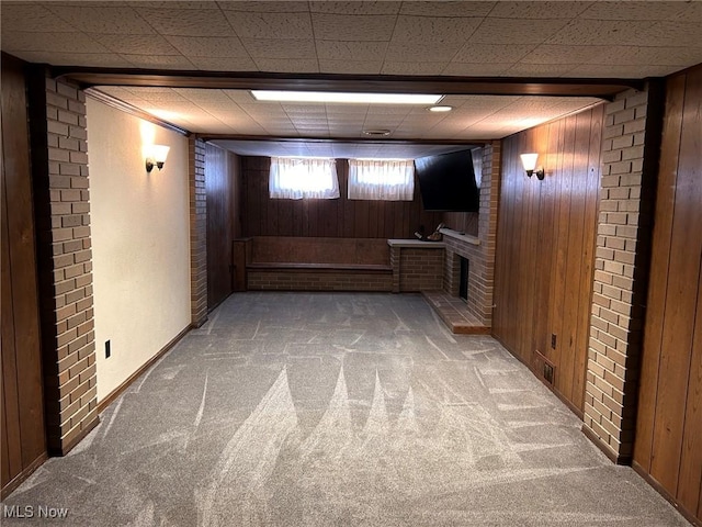 below grade area with wooden walls, carpet floors, and baseboards