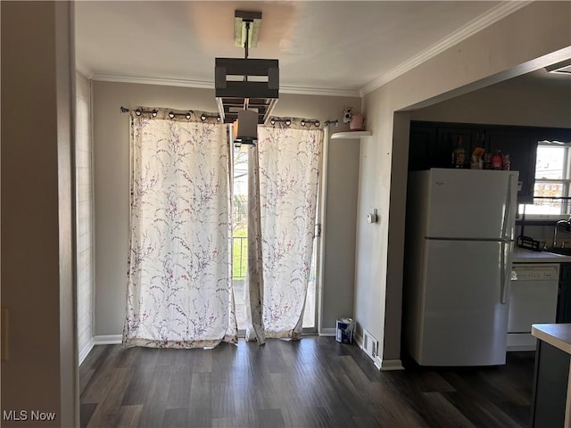 unfurnished dining area with crown molding, baseboards, dark wood-style floors, and visible vents