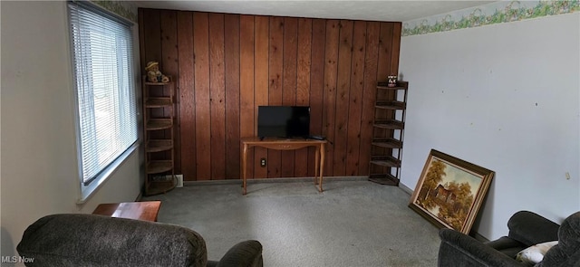 1352 Madison Ave, Lorain, OH 44053 - carpeted living room featuring plenty of natural light, wooden walls, and baseboards