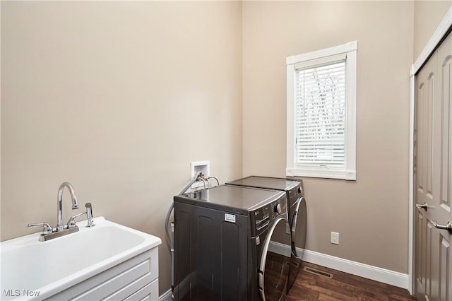 810 Point Dr, Akron, OH 44319 - laundry room with laundry area, dark wood-style flooring, a sink, washer and dryer, and baseboards