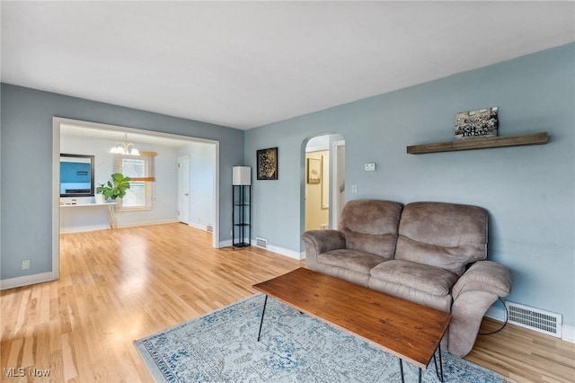 43 Hamilton Ave, Poland, OH 44514 - living area with visible vents, baseboards, arched walkways, and wood finished floors