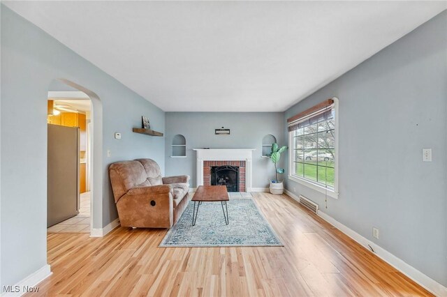 43 Hamilton Ave, Poland, OH 44514 - living area featuring a brick fireplace, arched walkways, wood finished floors, and baseboards