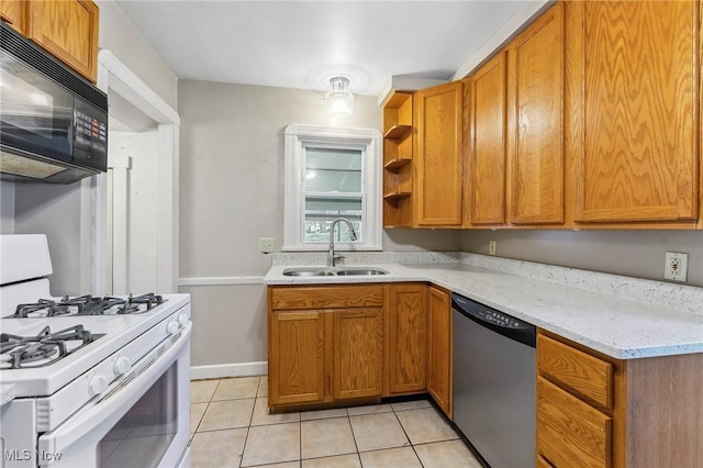 43 Hamilton Ave, Poland, OH 44514 - kitchen with light tile patterned floors, dishwasher, a sink, black microwave, and white gas range oven