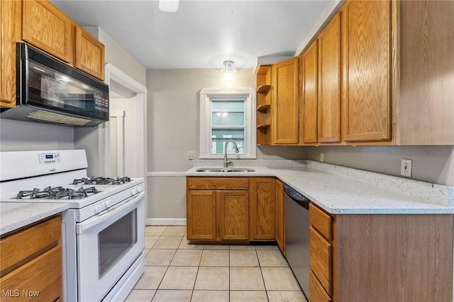 43 Hamilton Ave, Poland, OH 44514 - kitchen with white gas stove, black microwave, light tile patterned floors, stainless steel dishwasher, and a sink