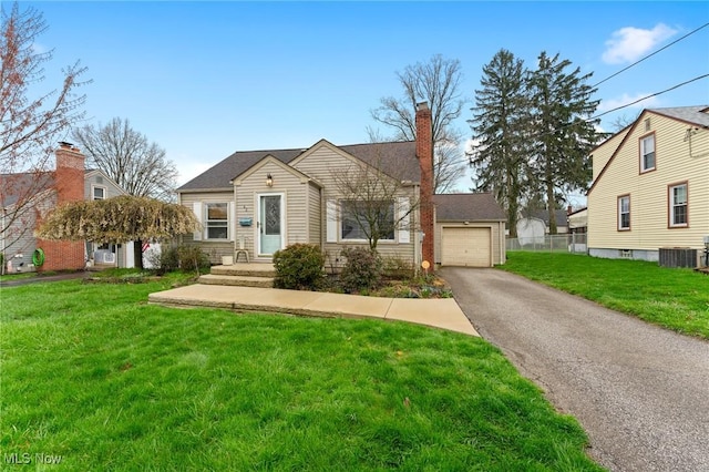 43 Hamilton Ave, Poland, OH 44514 - bungalow-style home with a chimney, driveway, central AC unit, and a front lawn