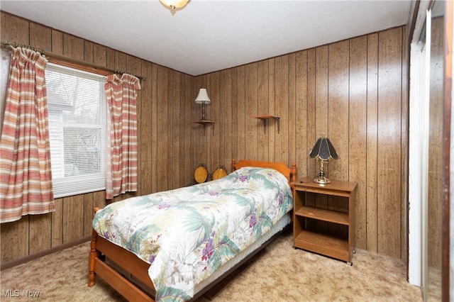 bedroom with wood walls and carpet