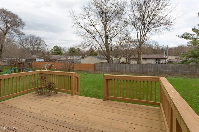 wooden deck with a fenced backyard, a playground, a residential view, and a lawn
