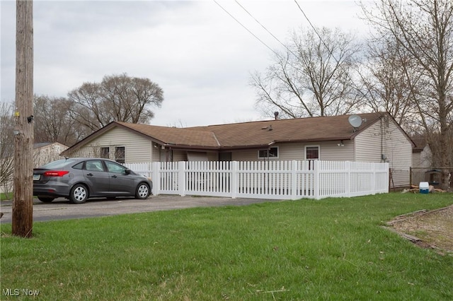 view of front of property with a front lawn and a fenced front yard