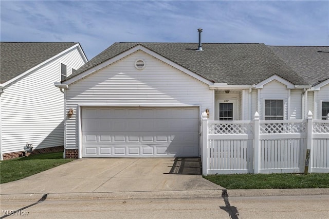 view of front of property featuring roof with shingles, fence, a garage, and concrete driveway