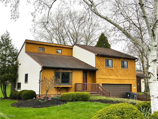 7366 Cromwell Dr, Solon, OH 44139 - view of front of home with a shingled roof, a garage, and a front yard