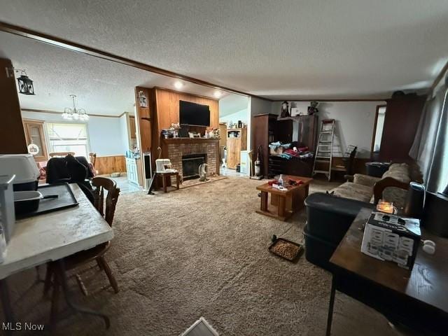 living area featuring a textured ceiling, wooden walls, a fireplace, and carpet flooring