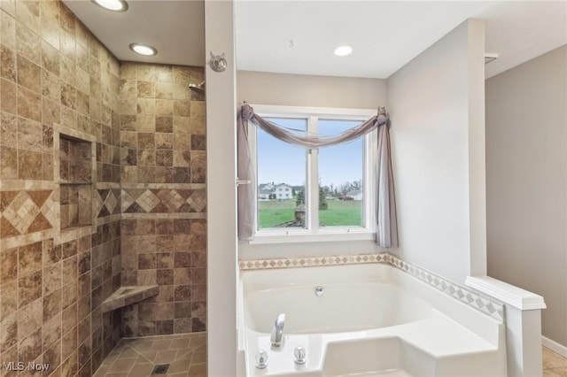 bathroom with a tile shower, recessed lighting, and a garden tub