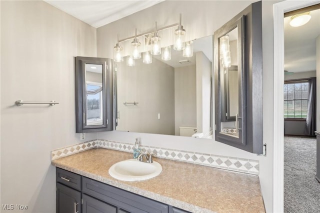 bathroom with vanity and toilet