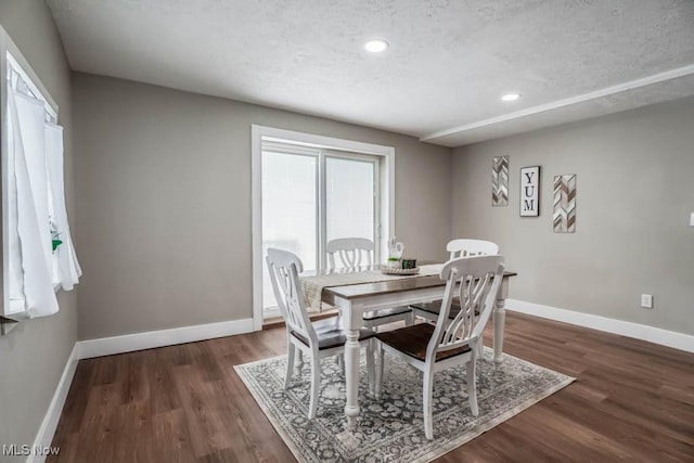 dining area featuring recessed lighting, baseboards, and wood finished floors
