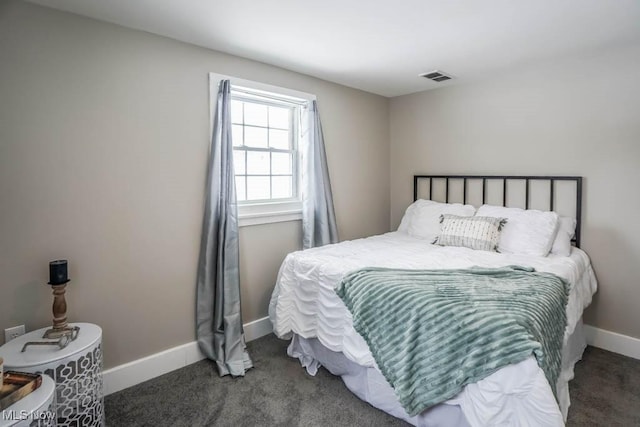 bedroom featuring visible vents, baseboards, and carpet