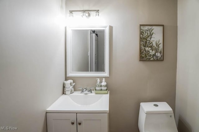 bathroom featuring toilet and vanity
