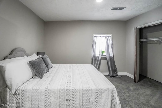 carpeted bedroom with a closet and visible vents