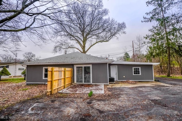 rear view of property featuring central AC