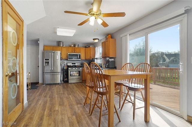 dining space featuring a ceiling fan and wood finished floors