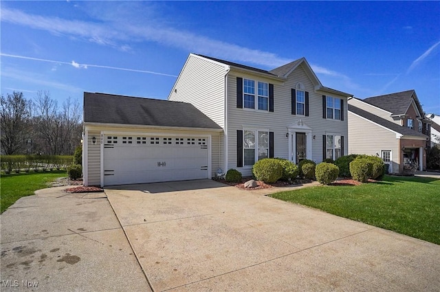 colonial-style house with concrete driveway, a front yard, and an attached garage