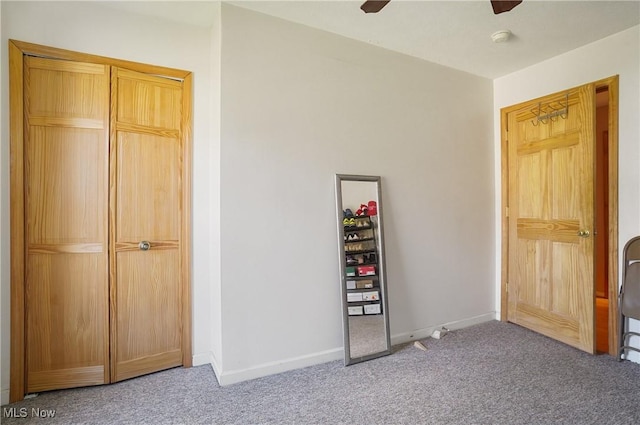 unfurnished bedroom featuring ceiling fan, carpet flooring, and baseboards