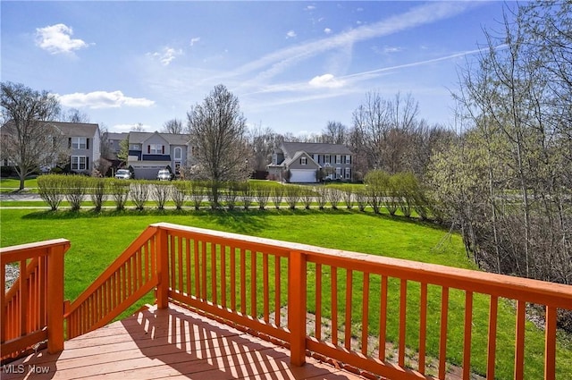 wooden terrace with a yard and a residential view