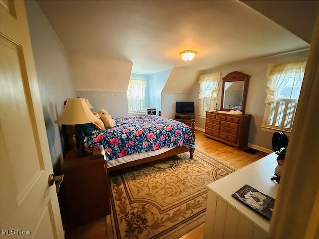 bedroom featuring light wood-style flooring and baseboards