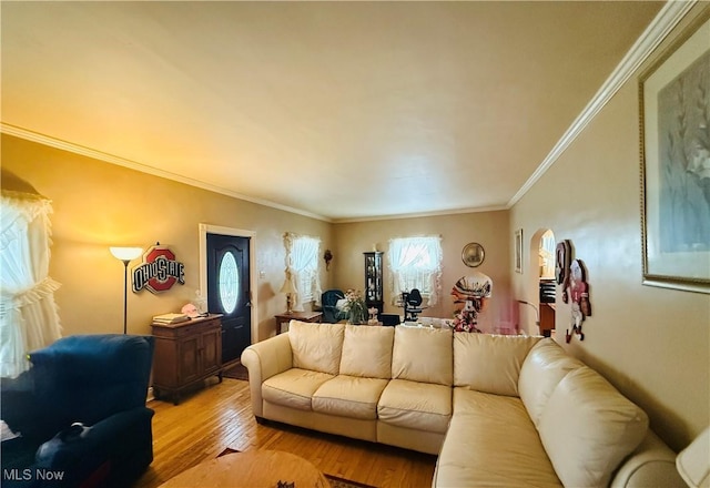 living room with ornamental molding and light wood-style floors