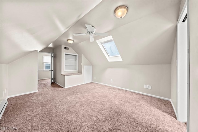 additional living space featuring baseboards, visible vents, ceiling fan, and carpet