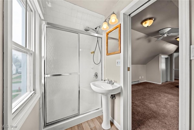full bathroom with a shower stall, a ceiling fan, lofted ceiling, and a wealth of natural light
