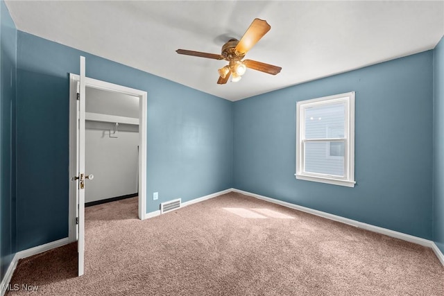 unfurnished bedroom featuring a closet, baseboards, carpet, and visible vents