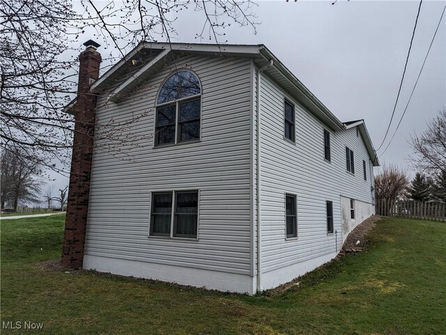 14864 Hayes Rd, Middlefield, OH 44062 - view of home's exterior with a chimney and a yard