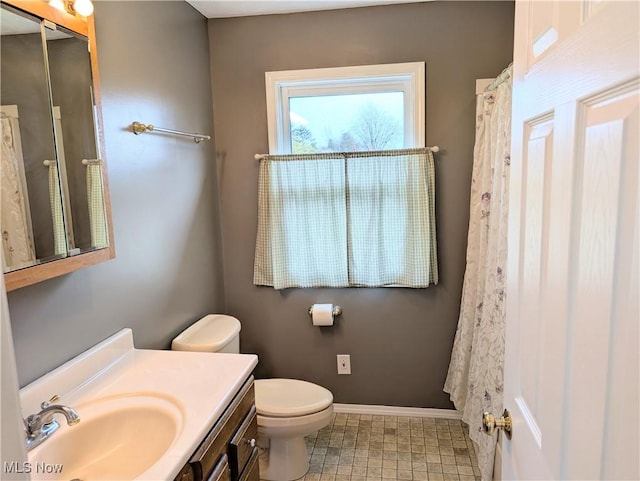14864 Hayes Rd, Middlefield, OH 44062 - bathroom featuring toilet, baseboards, and vanity