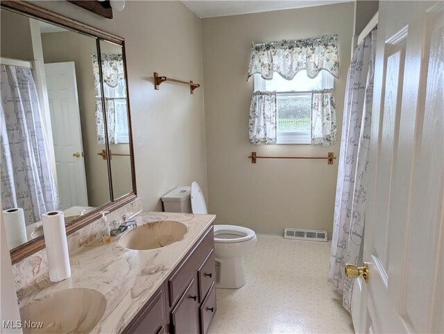 14864 Hayes Rd, Middlefield, OH 44062 - bathroom with tile patterned floors, toilet, and double vanity