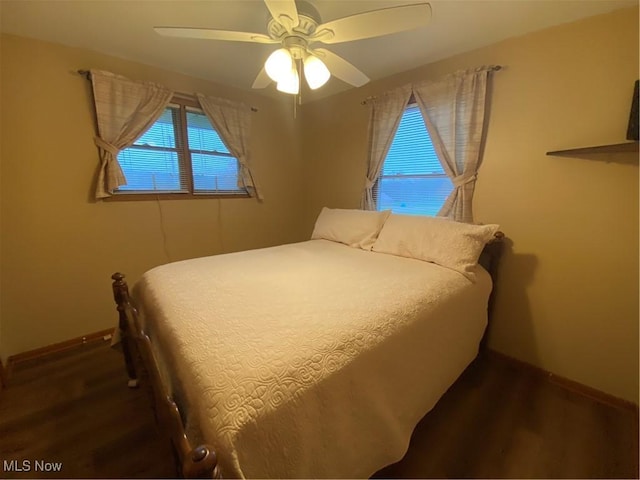 bedroom with baseboards, a ceiling fan, and wood finished floors