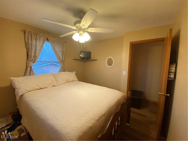 bedroom with a ceiling fan and wood finished floors